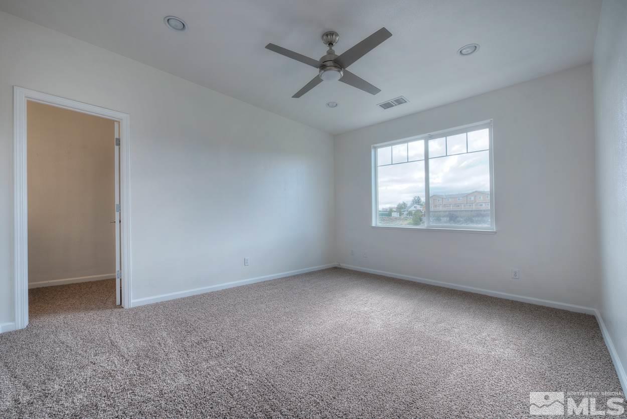 4800 Ciarra Kennedy Lane Reno, NV 89503 - Photo 12 of 25 an empty room with a window and a ceiling fan