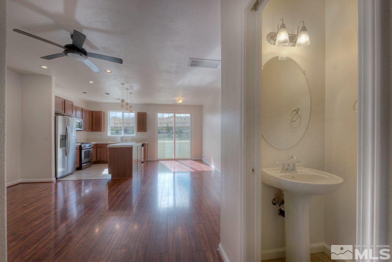 4800 Ciarra Kennedy Lane Reno, NV 89503 - Photo 4 of 25 a view of a room with wooden floor and a chandelier