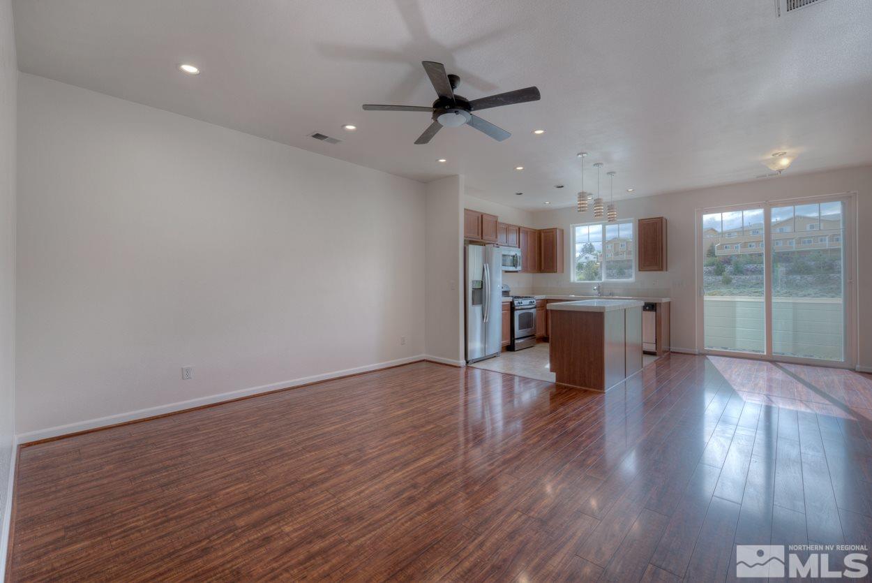 4800 Ciarra Kennedy Lane Reno, NV 89503 - Photo 5 of 25 a view of a kitchen with wooden floor and a ceiling fan
