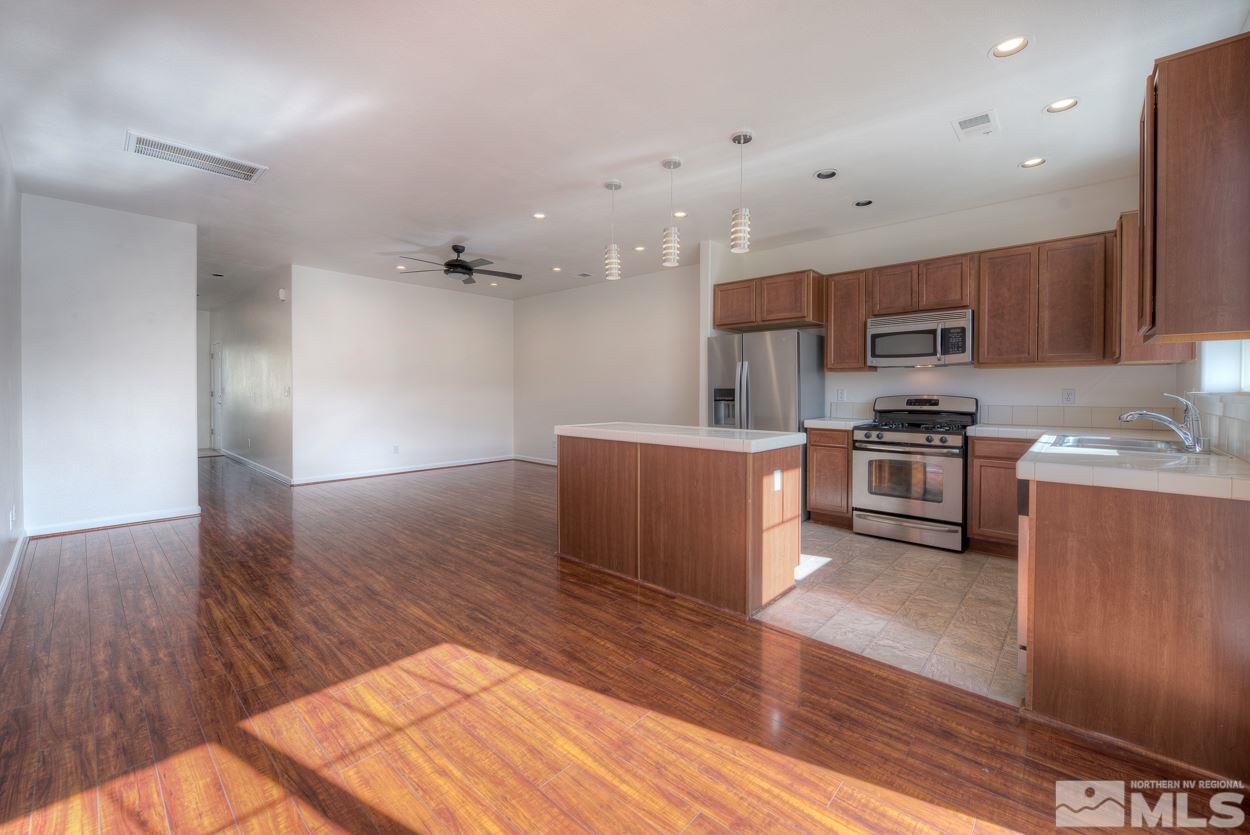 4800 Ciarra Kennedy Lane Reno, NV 89503 - Photo 7 of 25 a kitchen with stainless steel appliances granite countertop a refrigerator a sink a stove and oven