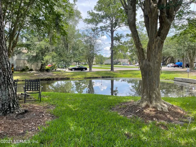 a view of a swimming pool with outdoor seating