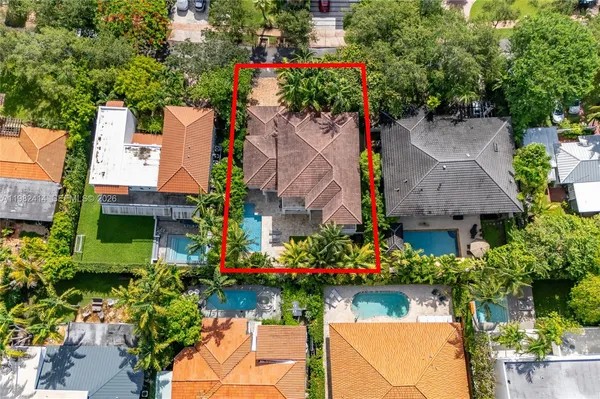 an aerial view of a house with a yard and garden