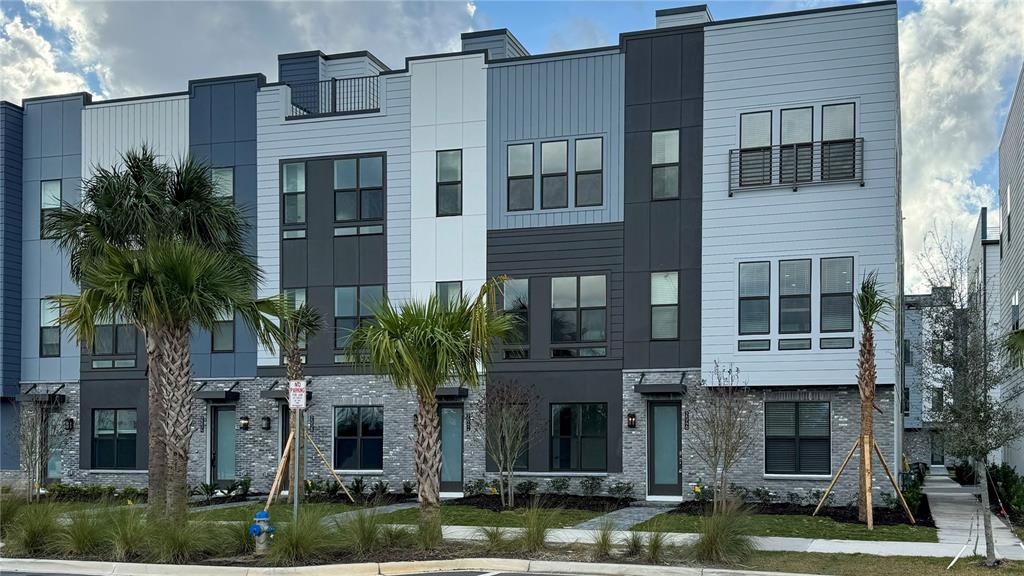 2046 Packing District Way Orlando, FL 32804 - Photo 1 of 1 a front view of a building with lots of windows and plants
