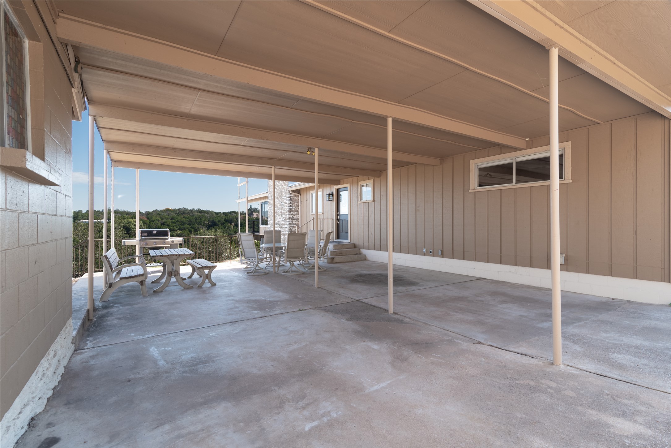 3807 Boat Dock Road Lago Vista, TX 78645 - Photo 24 of 37 An inviting covered patio offers ample space for outdoor entertaining with scenic hillside views.