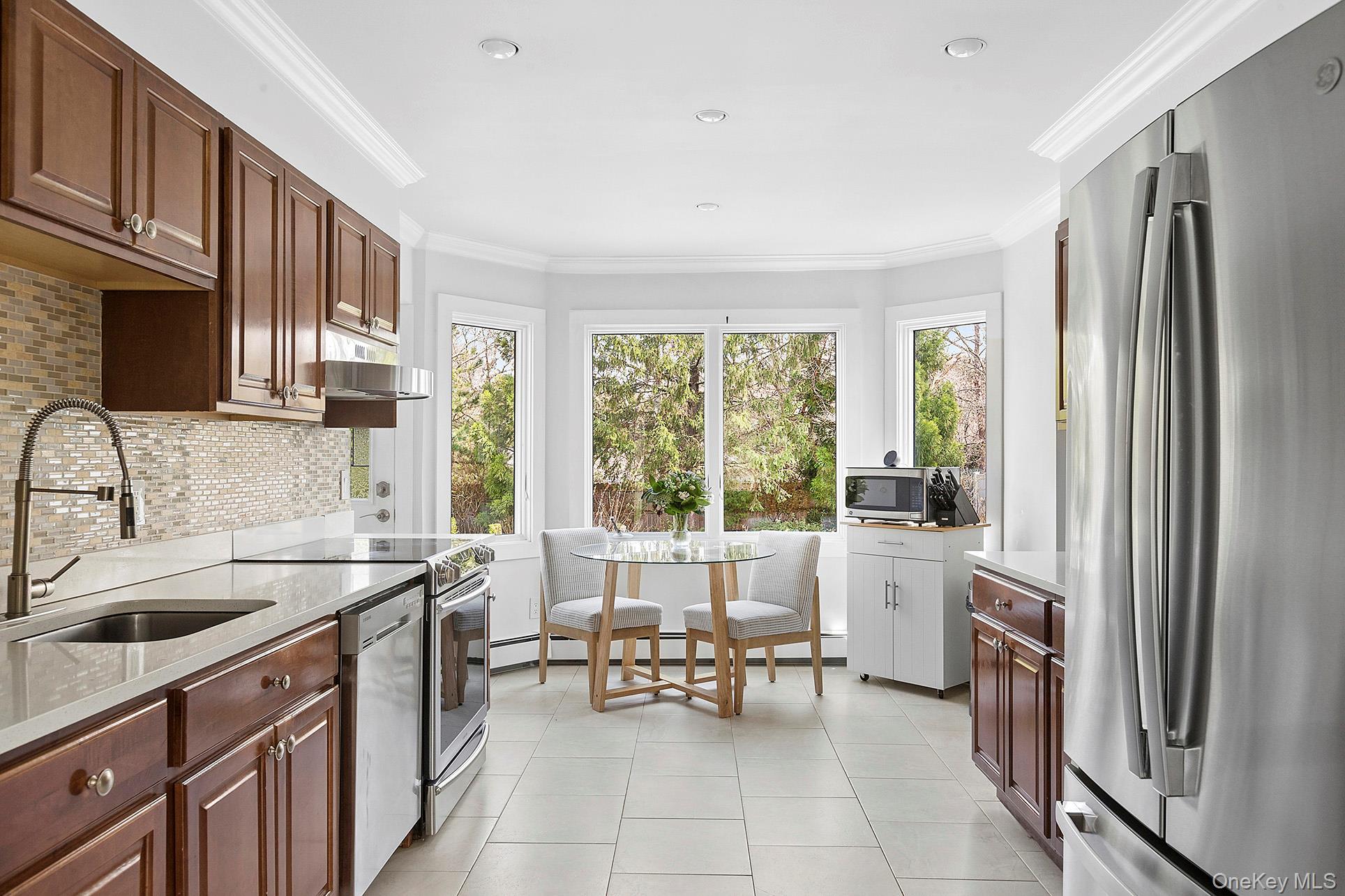3 Jones Road Hampton Bays, NY 11946 - Photo 5 of 19 a kitchen with a sink refrigerator and cabinets