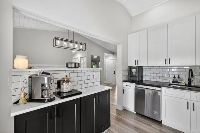 a kitchen with stainless steel appliances a sink and cabinets