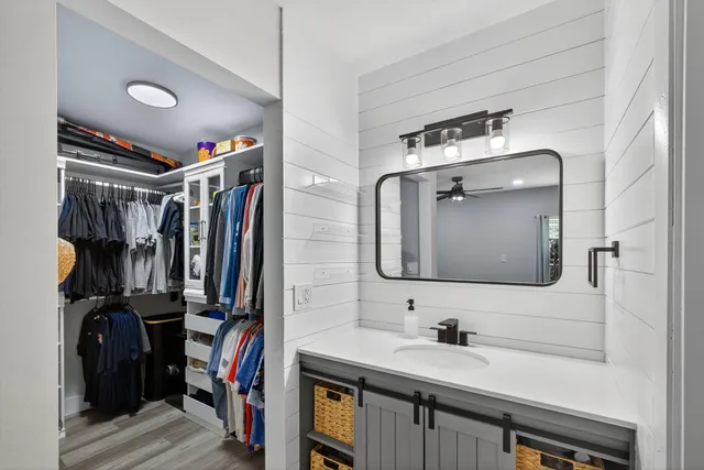 a bathroom with a sink a vanity and a mirror