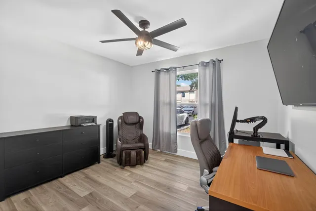 a view of a workspace with furniture and wooden floor