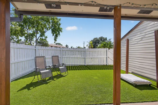 a view of a chair and table in the patio