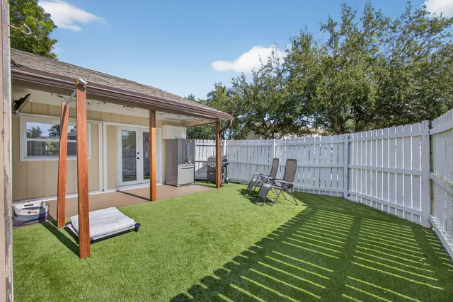 a view of a backyard with a sitting area