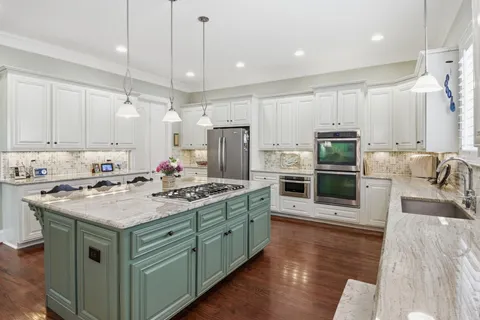 a utility room with stainless steel appliances and toys