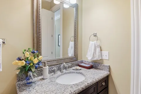 a bathroom with a sink vanity and a mirror