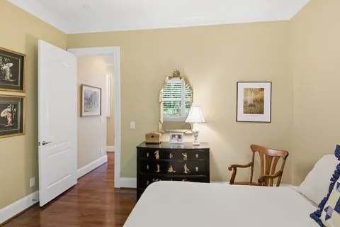 a bedroom with a bed and a table chair