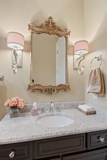 a bathroom with double sink and a mirror
