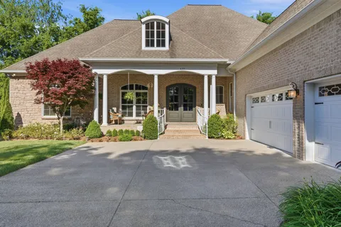 a front view of a house with outdoor seating and plants