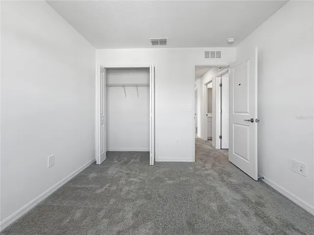 an empty room with closet area