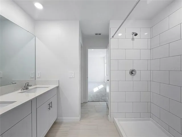 a spacious bathroom with a shower and a sink
