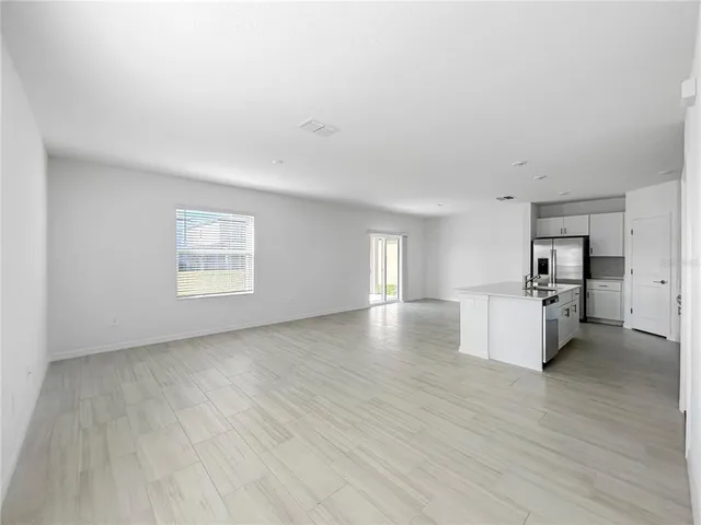 a view of a kitchen with furniture and wooden floor