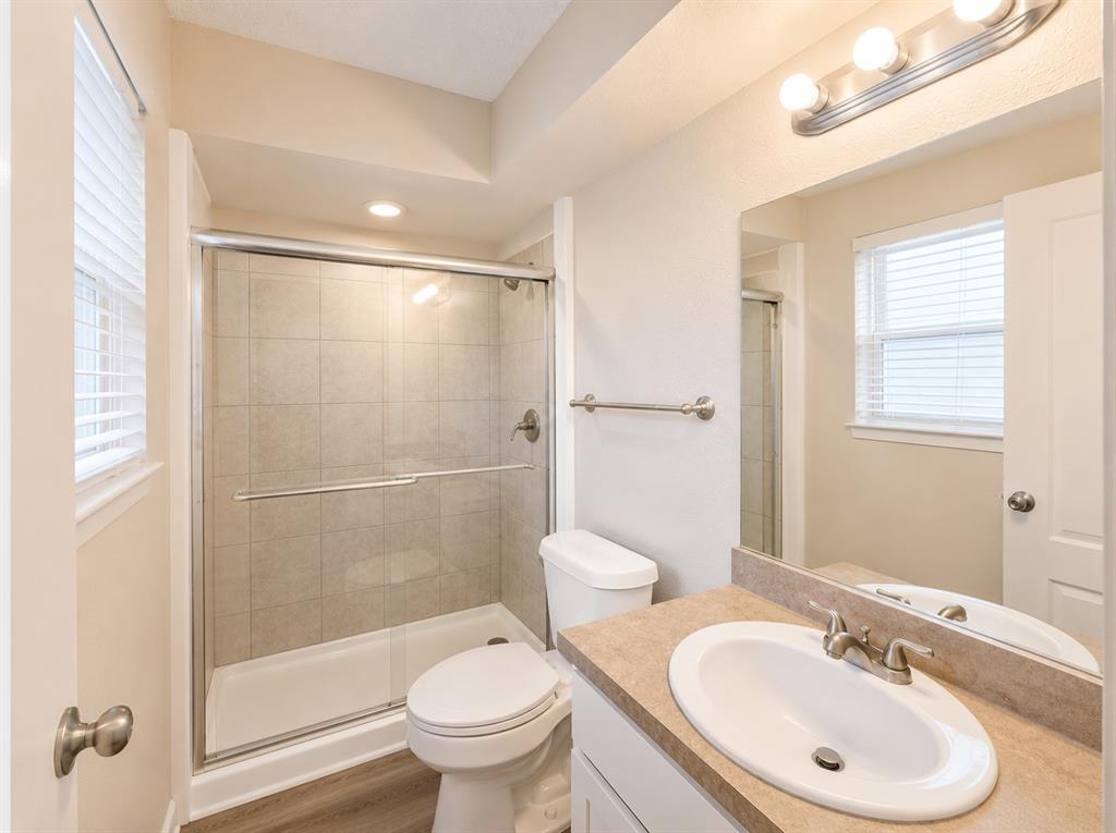 1231 Rutherford Drive Mesquite, TX 75149 - Photo 10 of 29 a bathroom with a sink toilet and shower