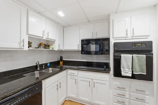 a kitchen with cabinets stainless steel appliances and a counter space