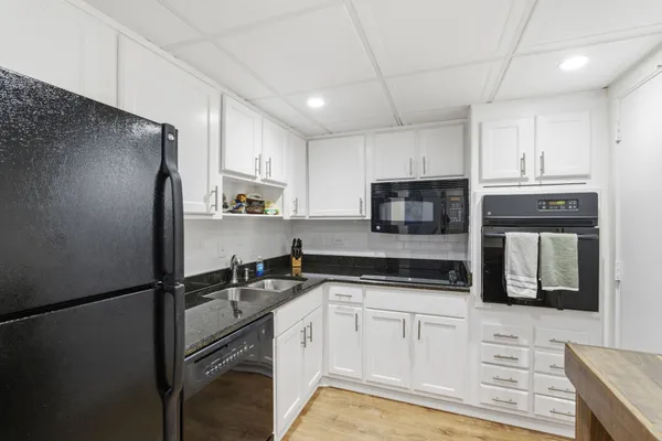 a kitchen with a refrigerator and a sink
