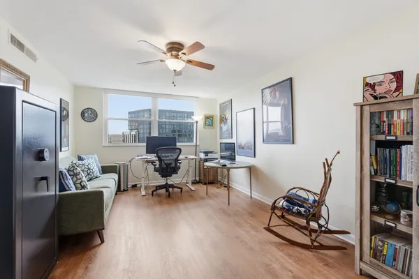 a living room with furniture and wooden floor