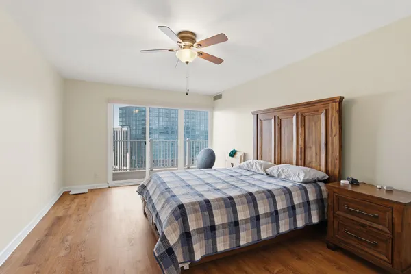 a bedroom with a bed a window and chandelier
