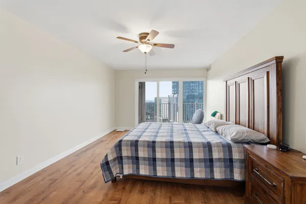a bedroom with a bed and a chandelier