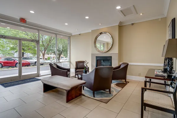 a living room with furniture a fireplace and a large window