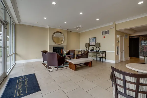 a living room with furniture a rug and a table