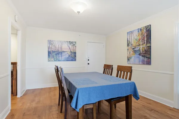 a view of a dining room with furniture and wooden floor