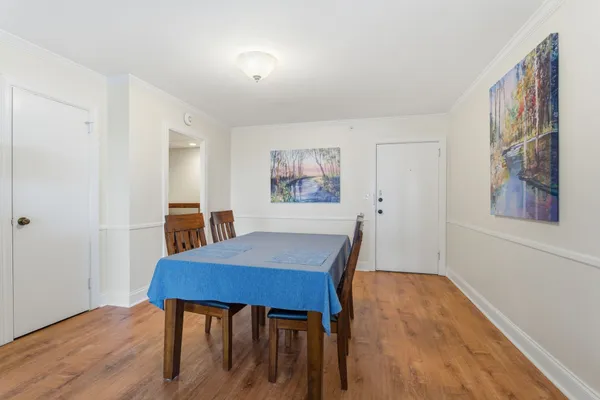 a view of a dining room with furniture and wooden floor