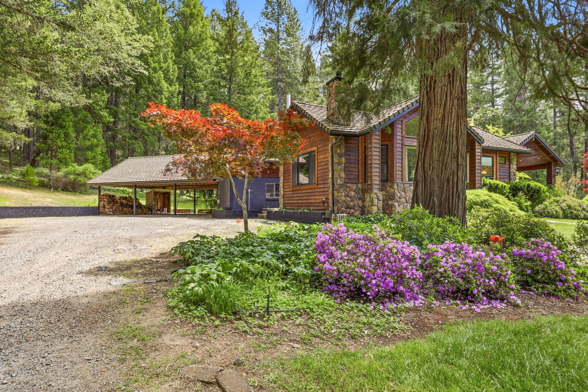985 Elliott Creek Road Wilderville, OR 97543 - Photo 91 of 98 a front view of a house with a yard and fountain