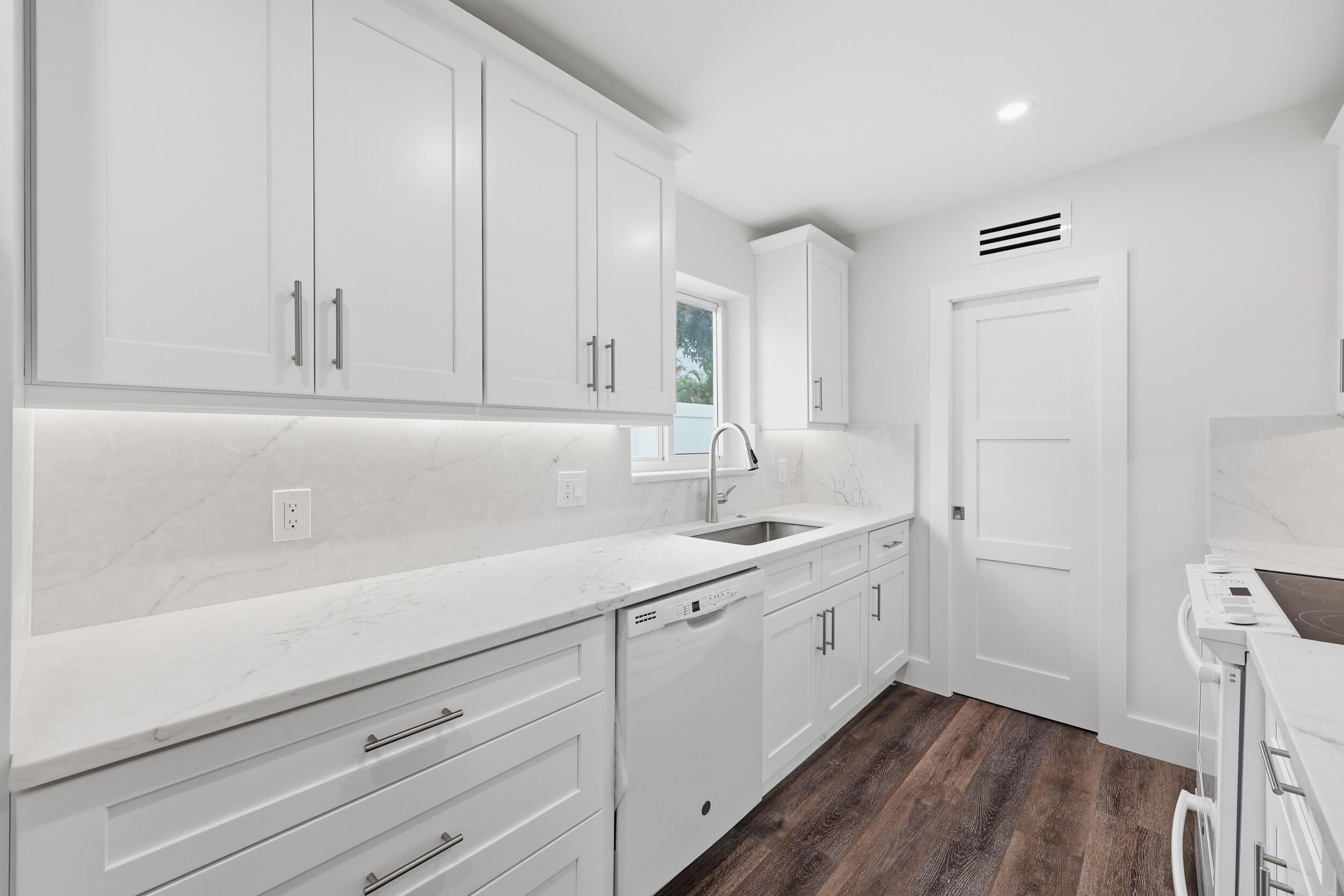 403 Todd Street Jupiter, FL 33458 - Photo 11 of 30 a kitchen with a sink cabinets and wooden floor