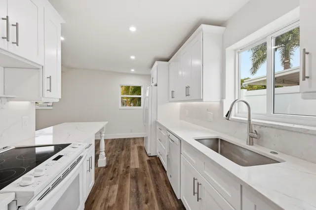 a kitchen with a sink and a stove top oven