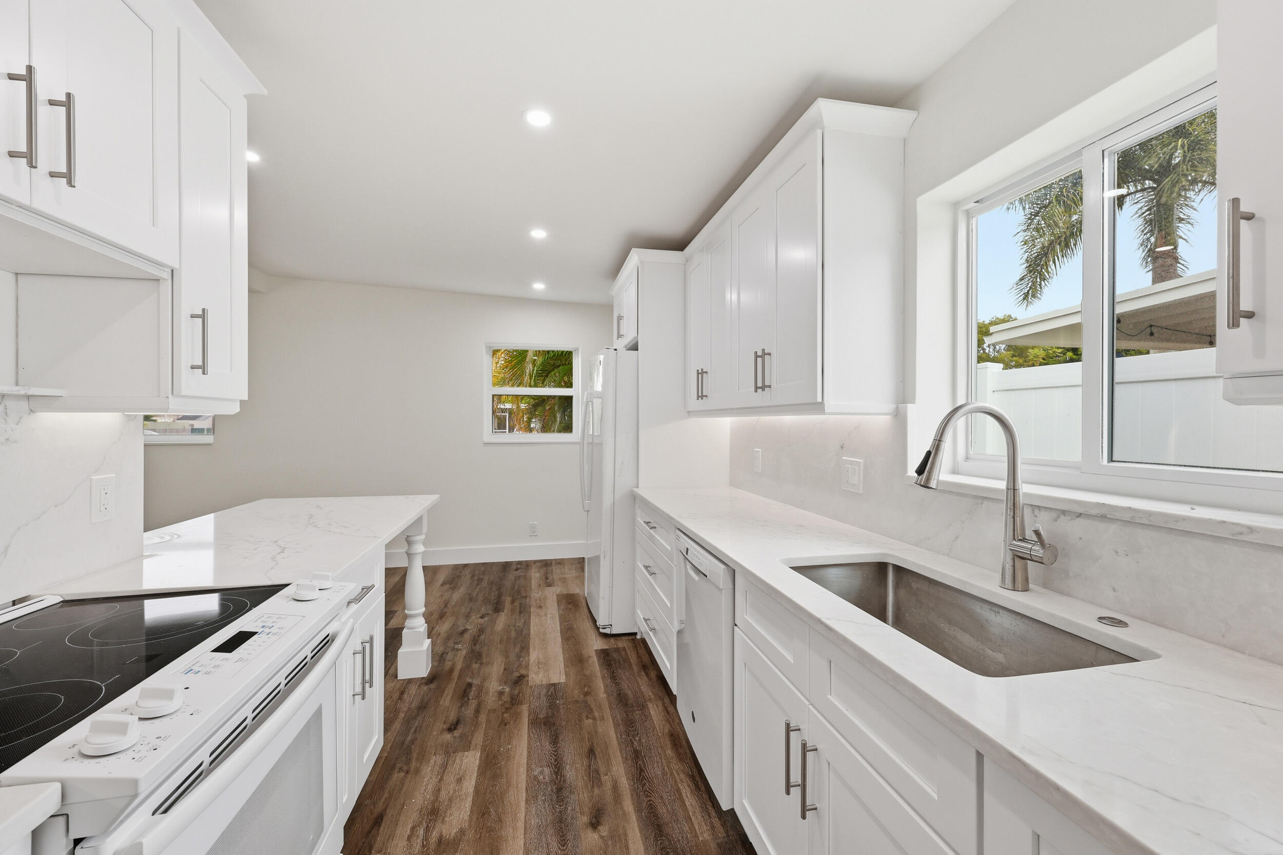 403 Todd Street Jupiter, FL 33458 - Photo 12 of 30 a kitchen with a sink and a stove top oven