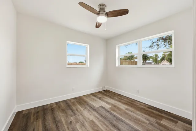 a view of empty room with wooden floor