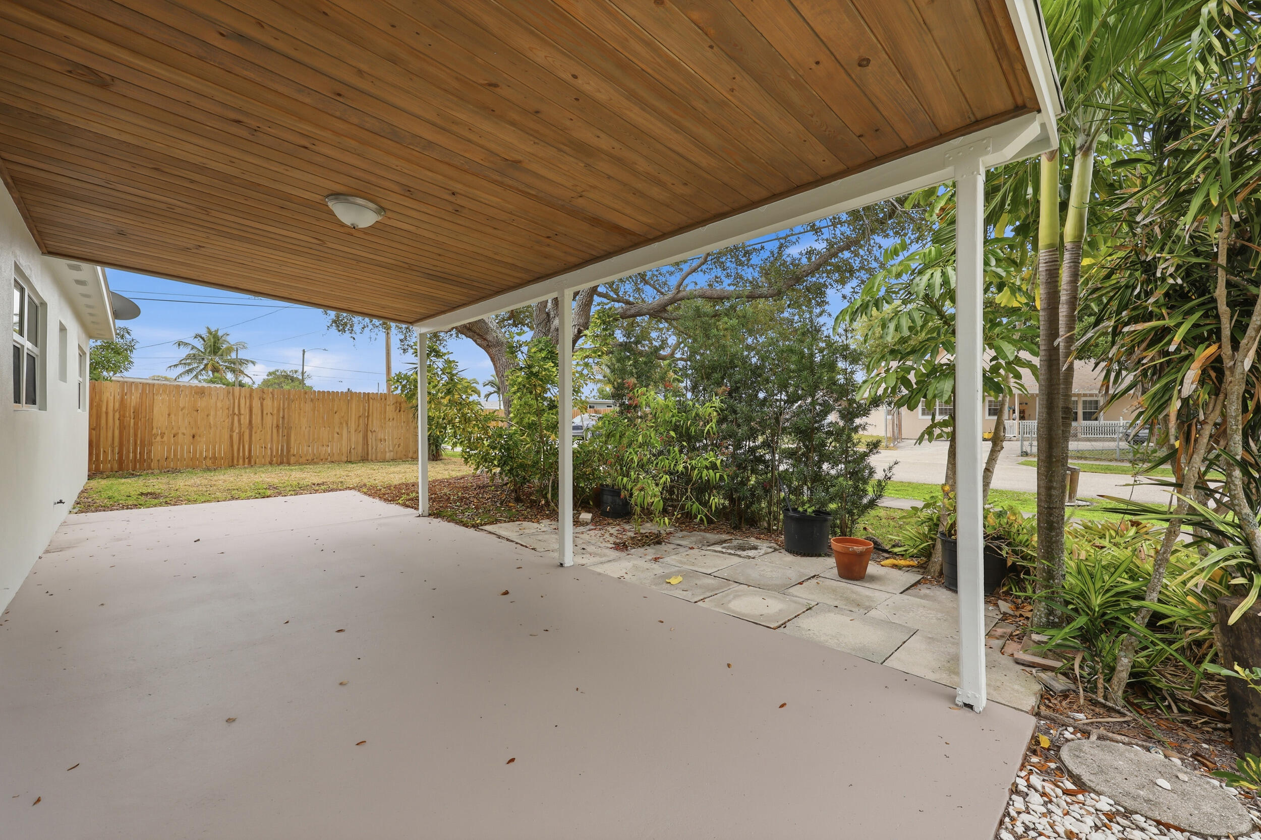 403 Todd Street Jupiter, FL 33458 - Photo 3 of 30 a view of backyard with plants and wooden fence