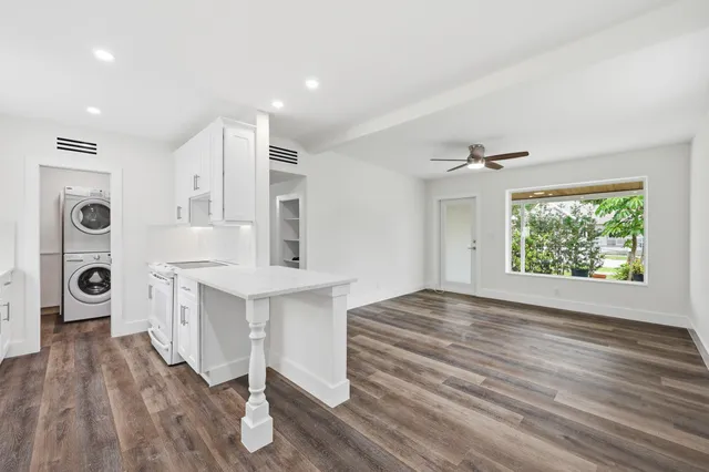 a view of kitchen and front door with wooden floor