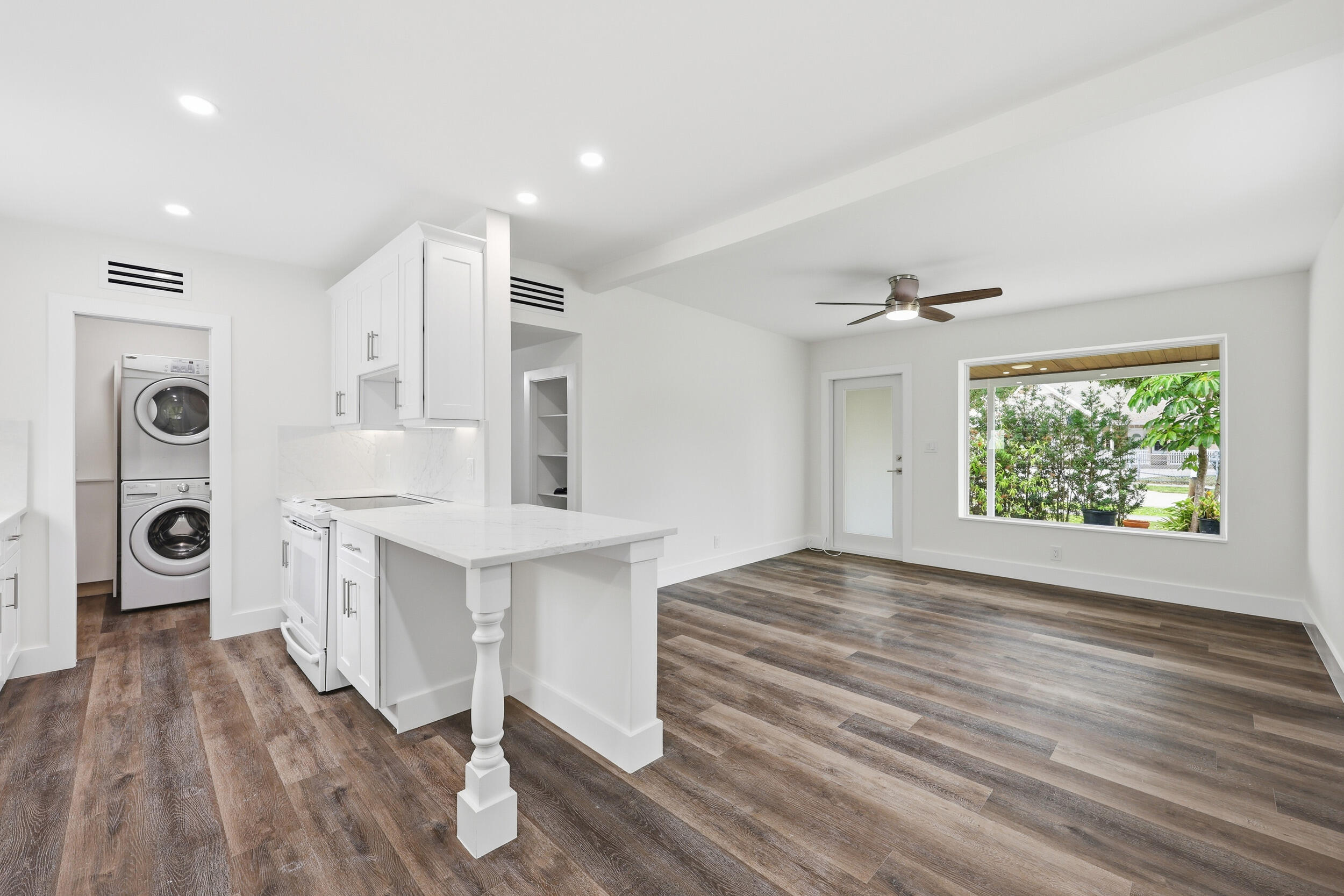 403 Todd Street Jupiter, FL 33458 - Photo 9 of 30 a view of kitchen and front door with wooden floor