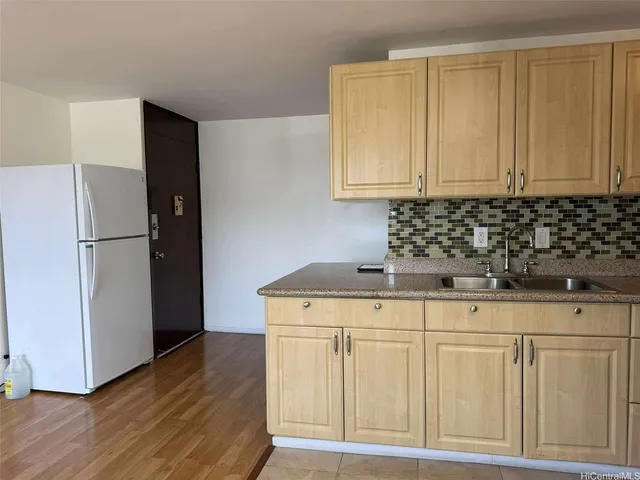 a kitchen with cabinets appliances and a counter space