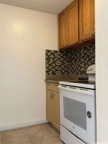 a stove top oven sitting inside of a kitchen