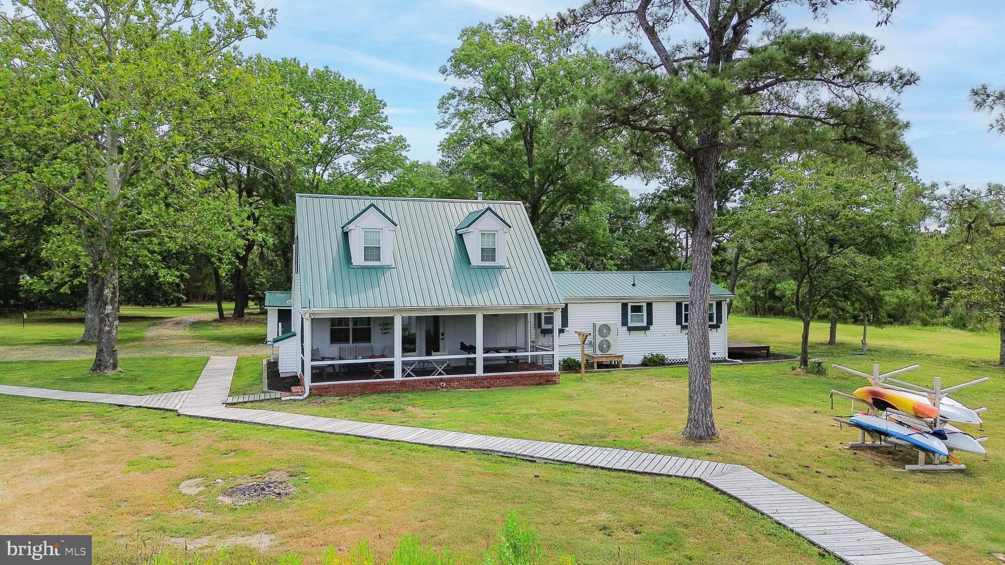 4004 Robinson Neck Road Taylors Island, MD 21669 - Photo 42 of 84 a view of a house with a big yard and large trees