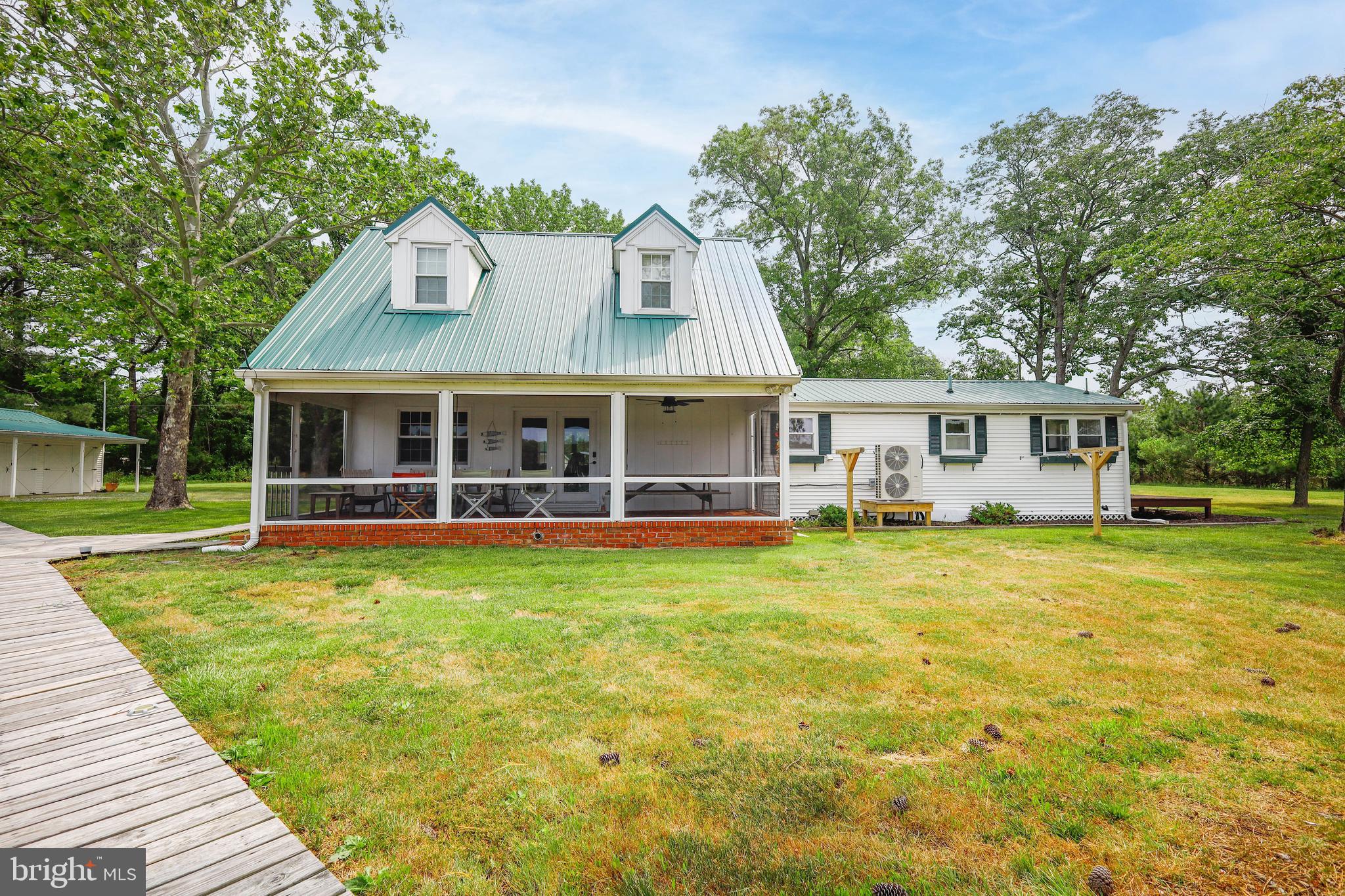 4004 Robinson Neck Road Taylors Island, MD 21669 - Photo 44 of 84 a view of a house with a yard and sitting area