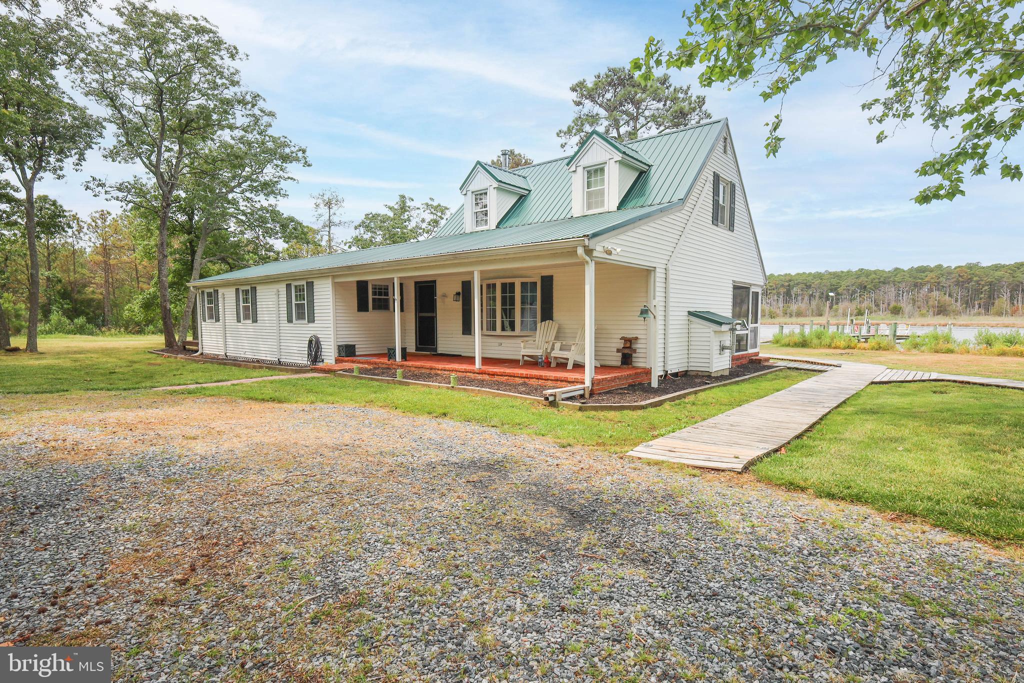 4004 Robinson Neck Road Taylors Island, MD 21669 - Photo 75 of 84 a view of a house with a yard and palm trees