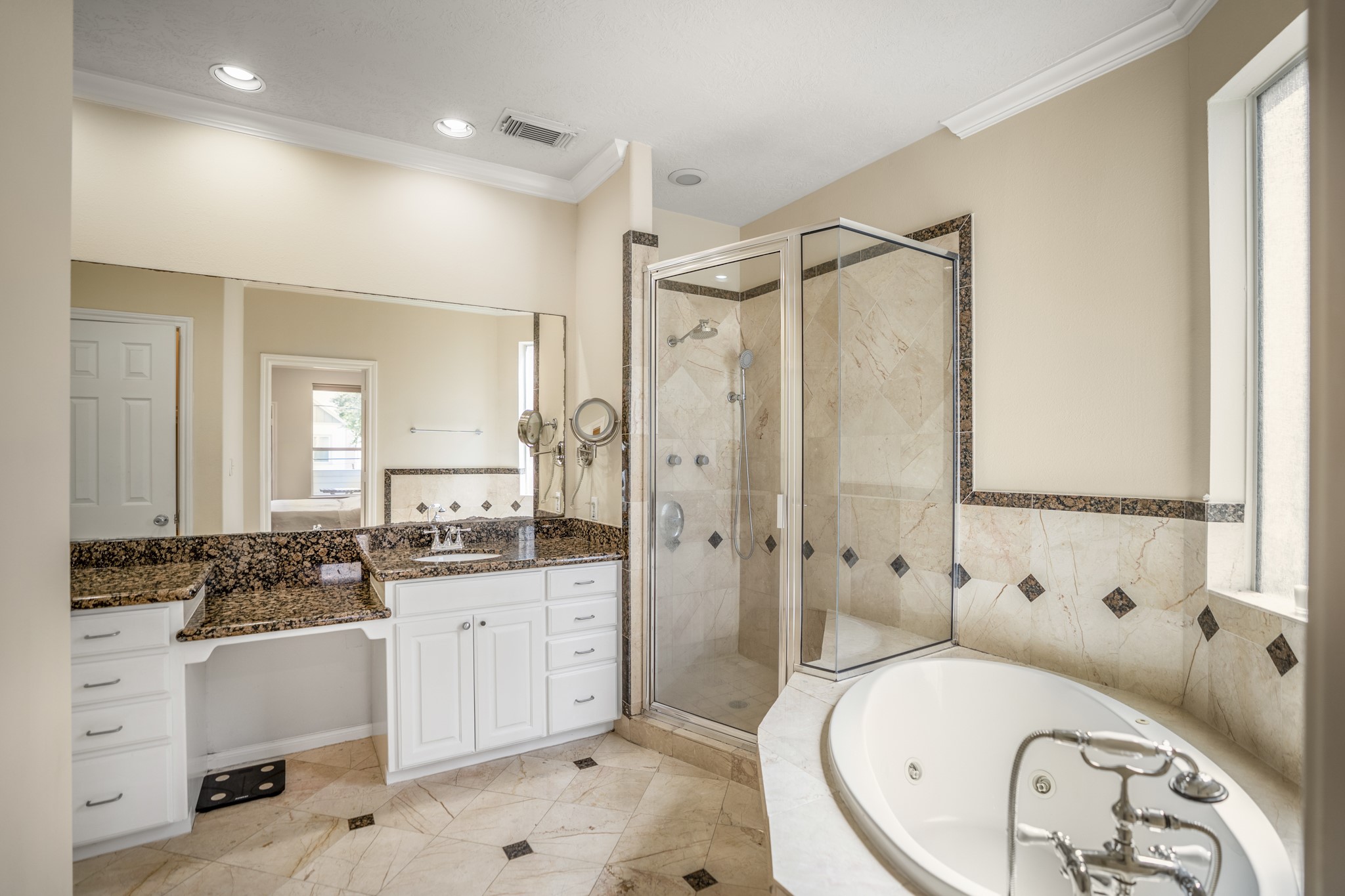 4236 Drake Street Houston, TX 77005 - Photo 21 of 43 The elegant primary ensuite bathroom showcases classic granite countertops, refined finishes, and a spacious layout, including a dedicated vanity space.