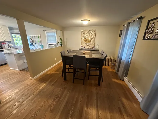 a view of a dining room with furniture and wooden floor
