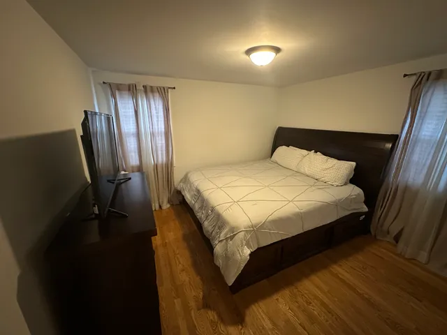 a bed sitting in a bedroom next to a window
