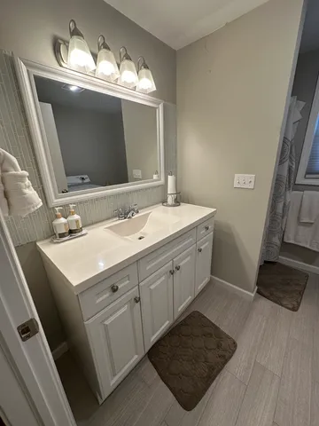 a bathroom with a sink double vanity granite and a mirror