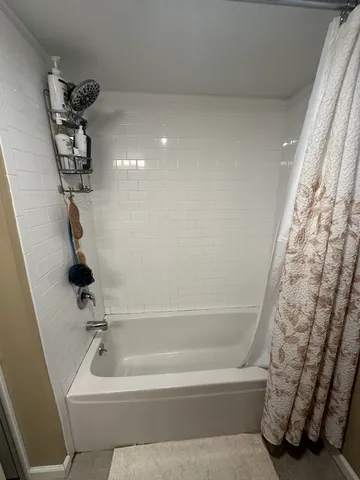 a bathroom with a bathtub and shower